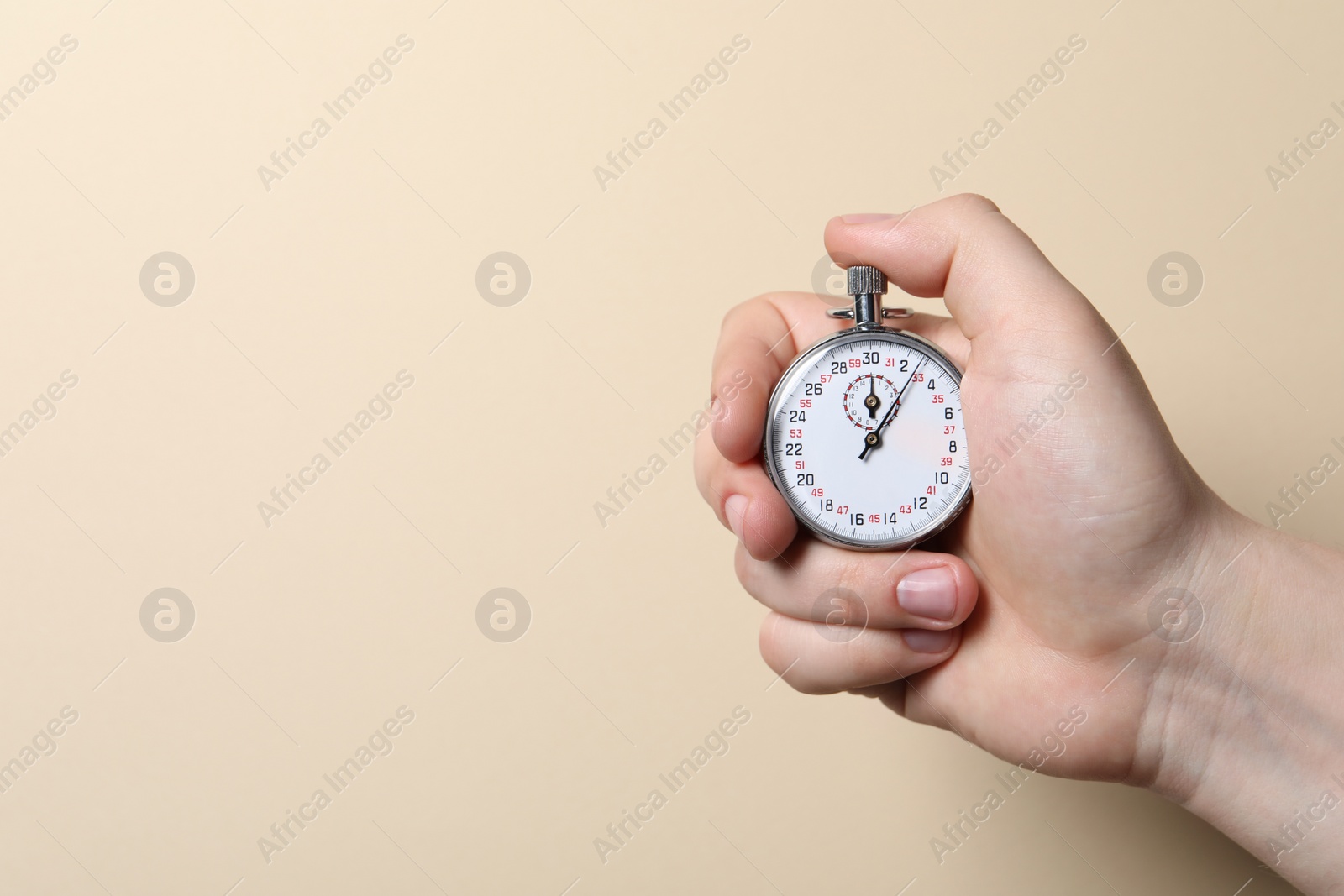 Photo of Man holding vintage timer on beige background, closeup. Space for text