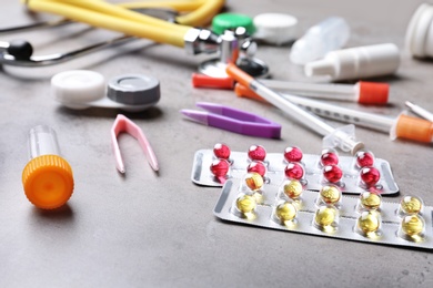 Set of medical objects on grey table