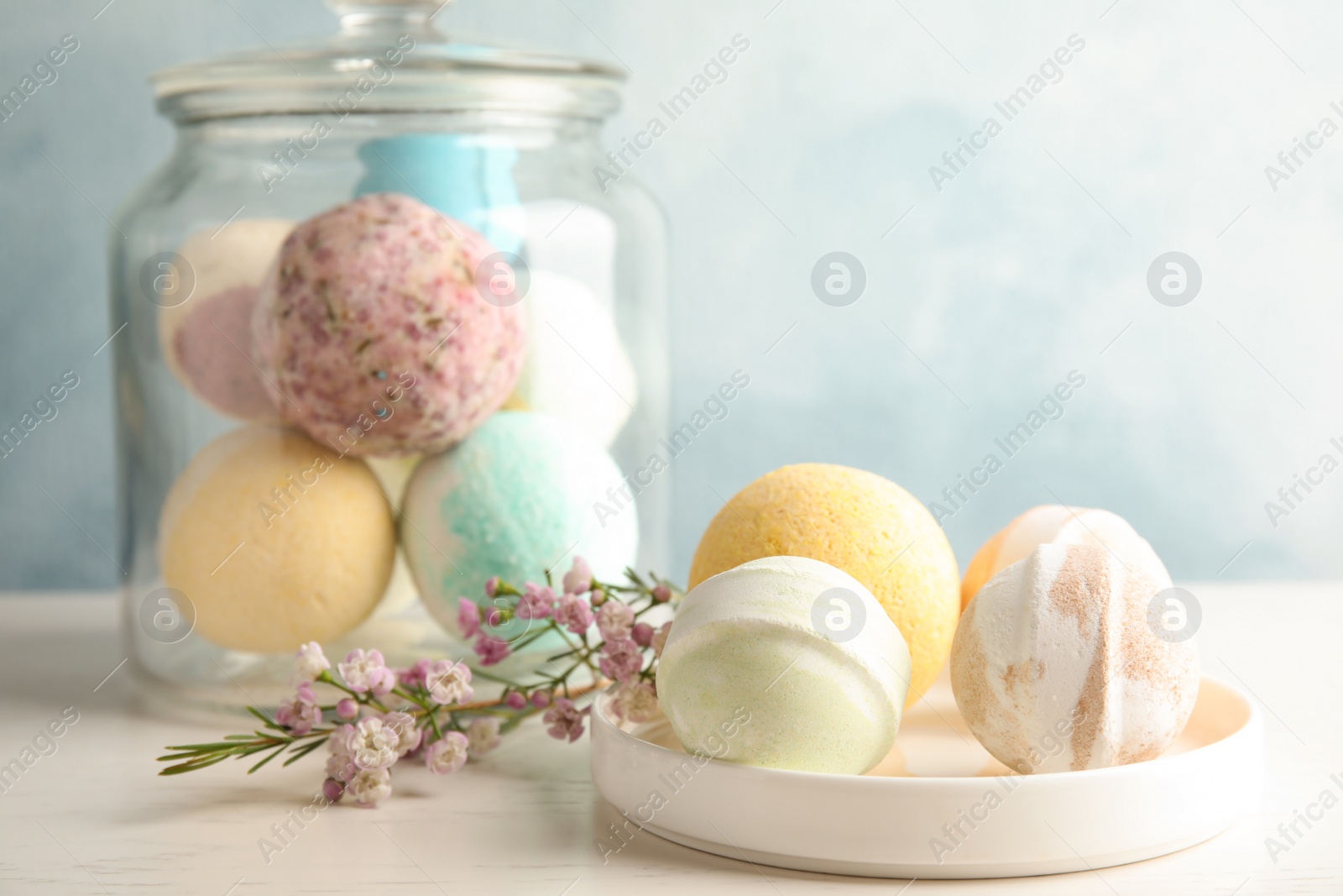 Photo of Plate with colorful bath bombs on table