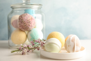 Plate with colorful bath bombs on table