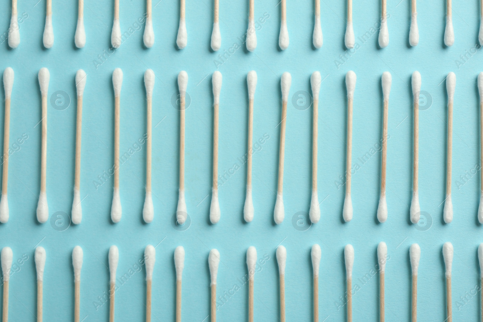 Photo of Flat lay composition with cotton swabs on color background