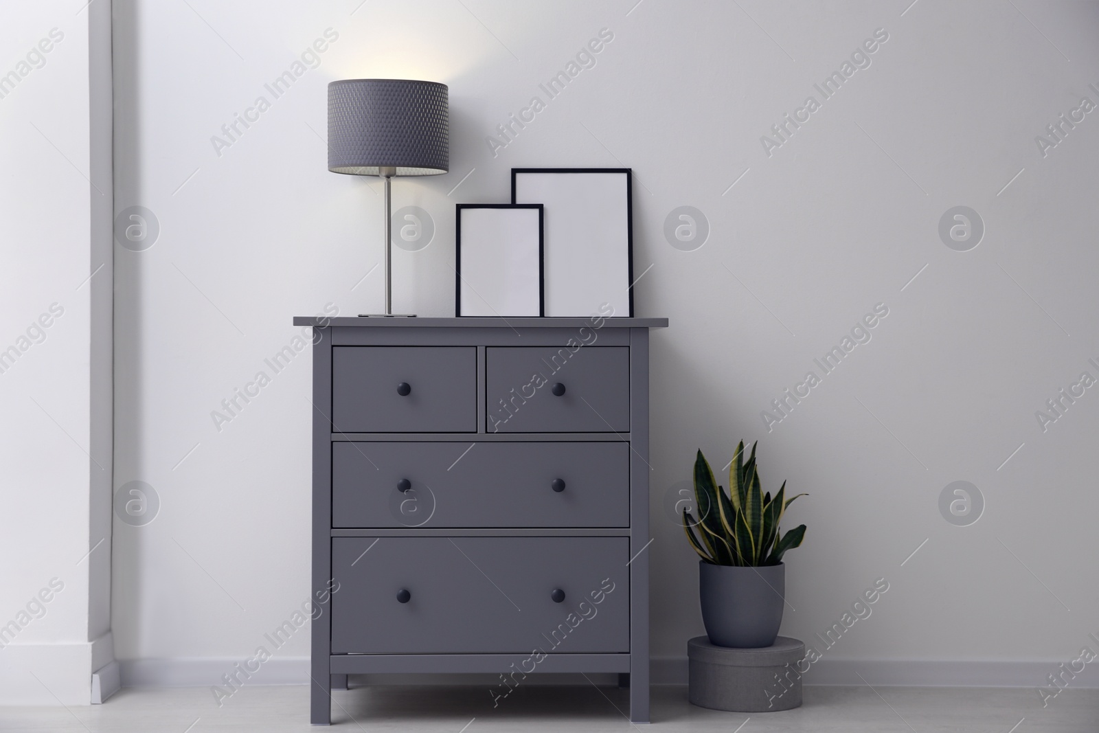 Photo of Grey chest of drawers in stylish room interior