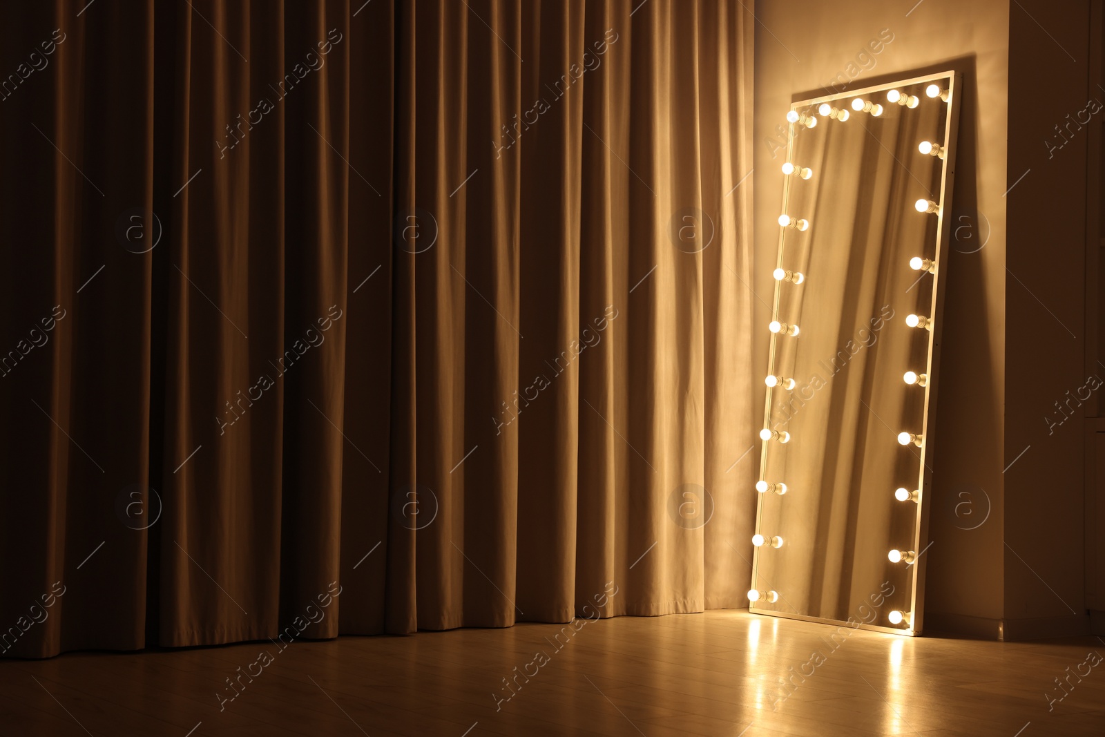 Photo of Modern mirror with light bulbs in makeup room