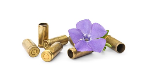 Photo of Bullet shells and beautiful flower on white background. Peace insteadwar
