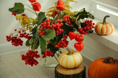 Photo of Beautiful autumn composition with different pumpkins indoors