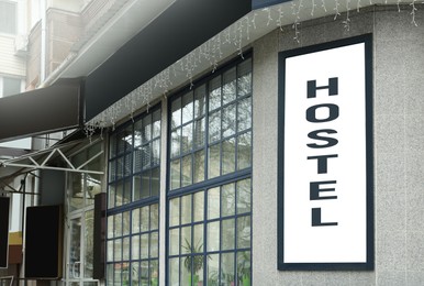 Image of HOSTEL sign board on building facade outdoors