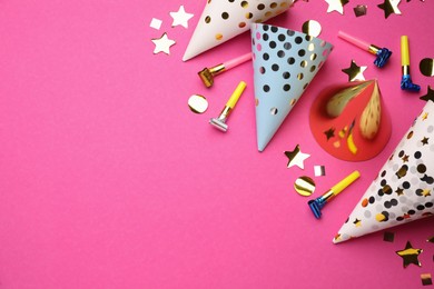 Photo of Flat lay composition with party hats and other festive items on bright pink background. Space for text