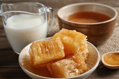 Photo of Composition with milk and honey on wooden background, closeup