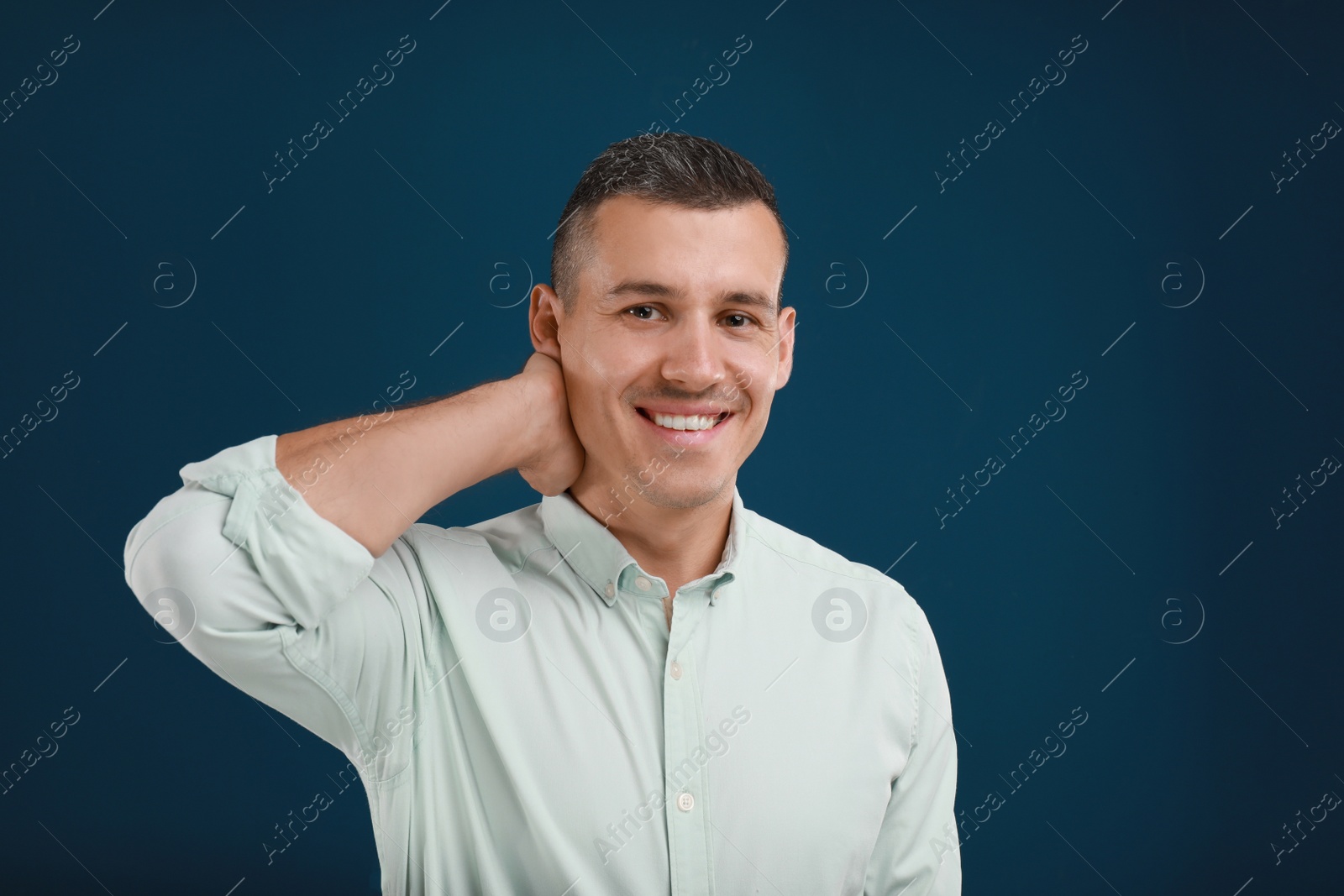 Photo of Portrait of handsome man on blue background