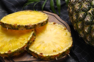 Slices of tasty ripe pineapple on table, closeup