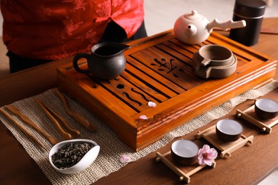 Traditional tea ceremony. Master near tools and tray, closeup