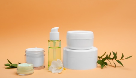 Photo of Composition with cosmetic products on color background