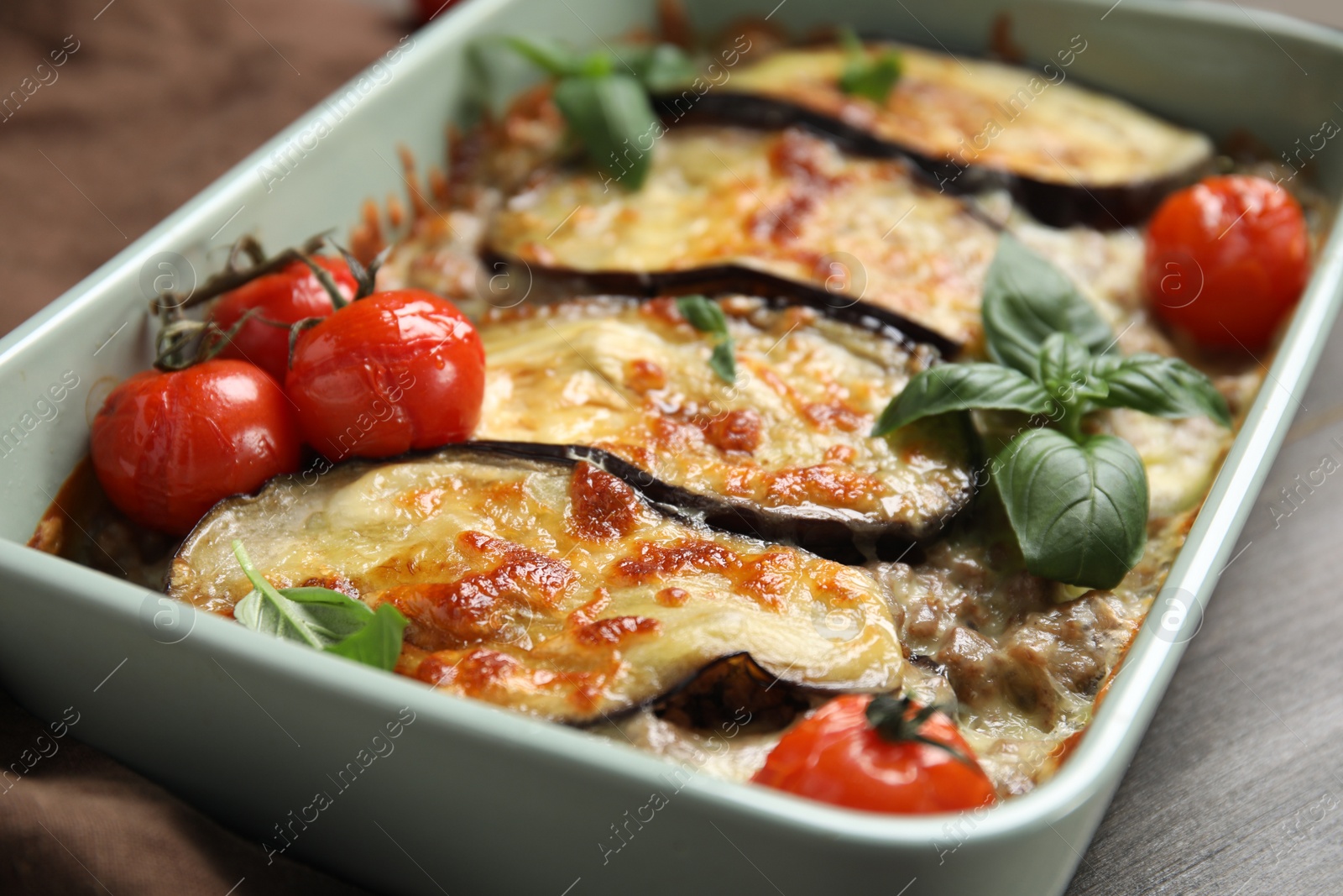 Photo of Delicious eggplant lasagna in baking dish on table, closeup