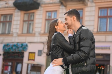 Lovely young couple together on city street. Romantic date