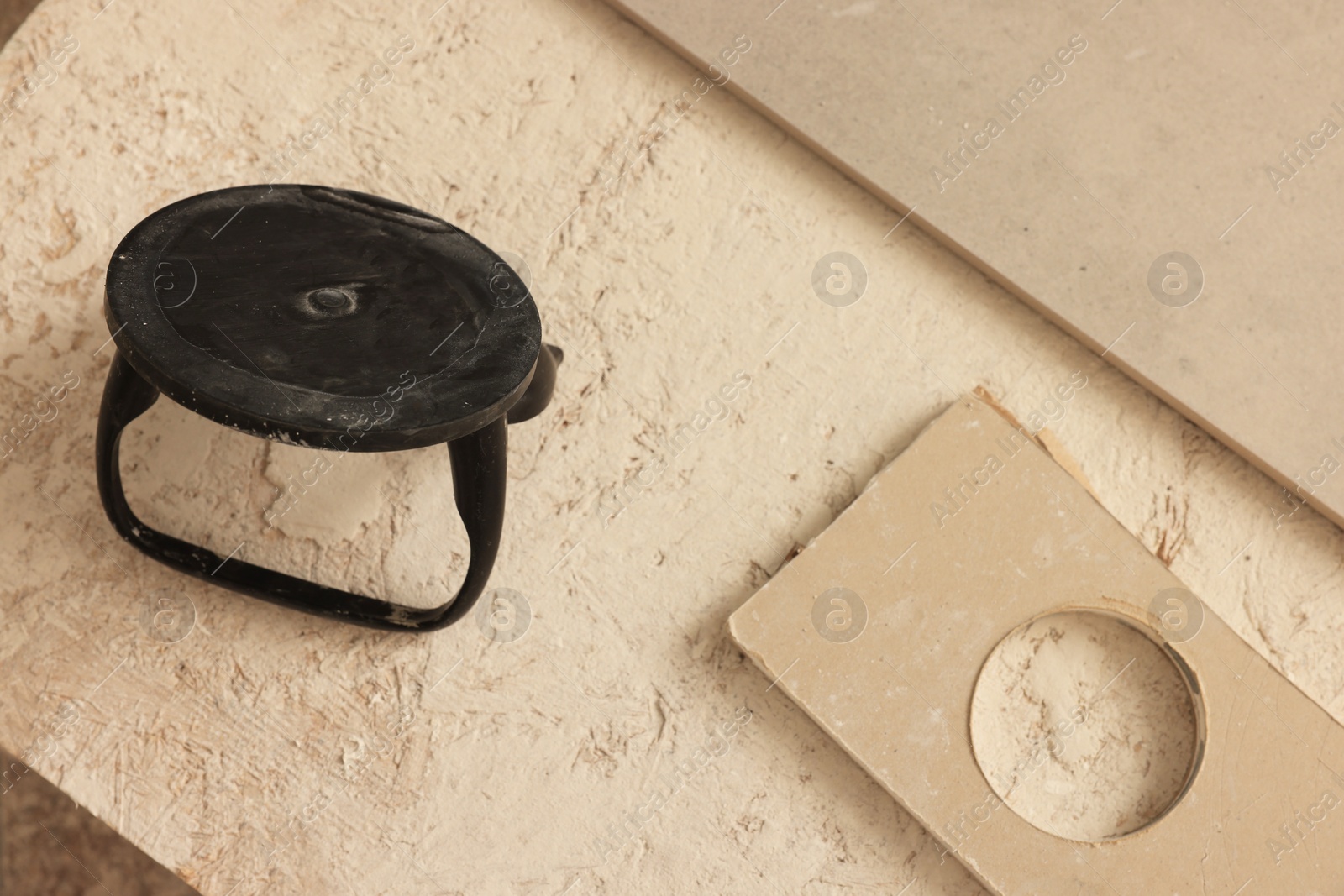 Photo of Glass suction plate on chipboard, above view. Tiles installation process