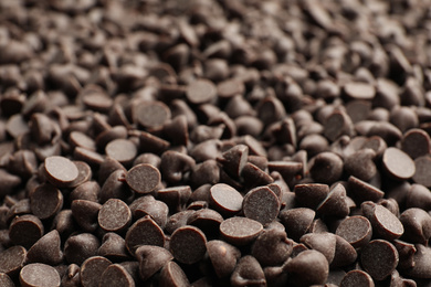 Photo of Delicious chocolate chips as background, closeup view