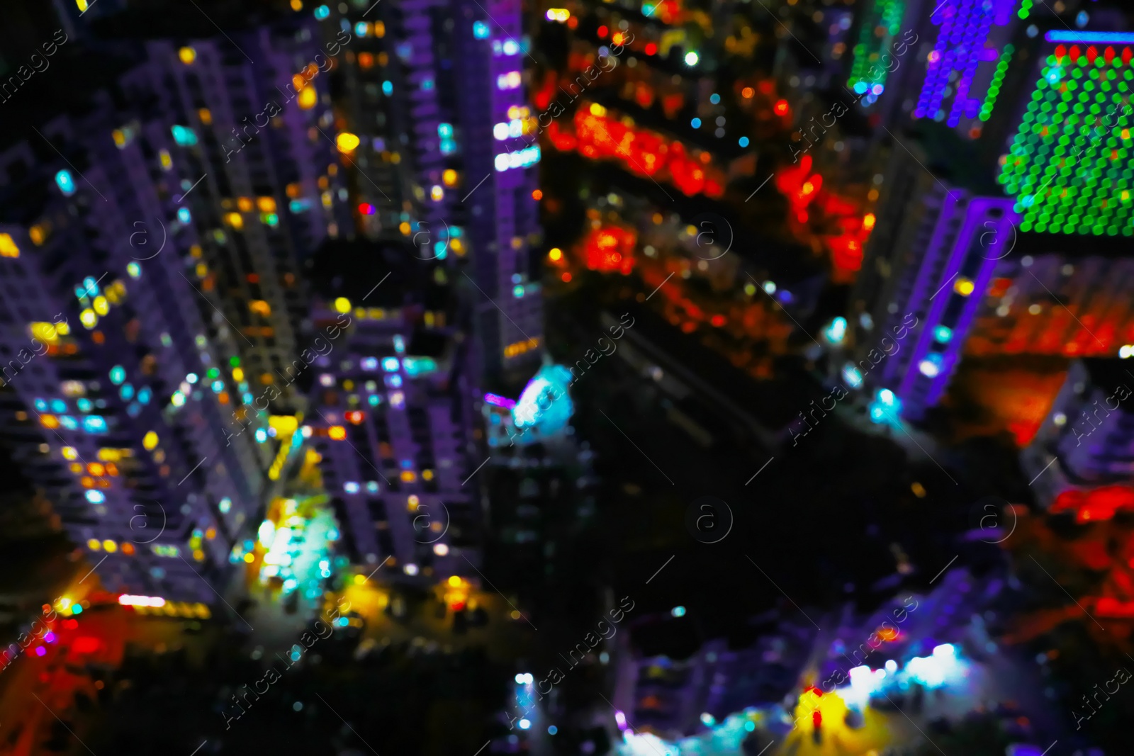 Photo of Blurred view of city with buildings at night