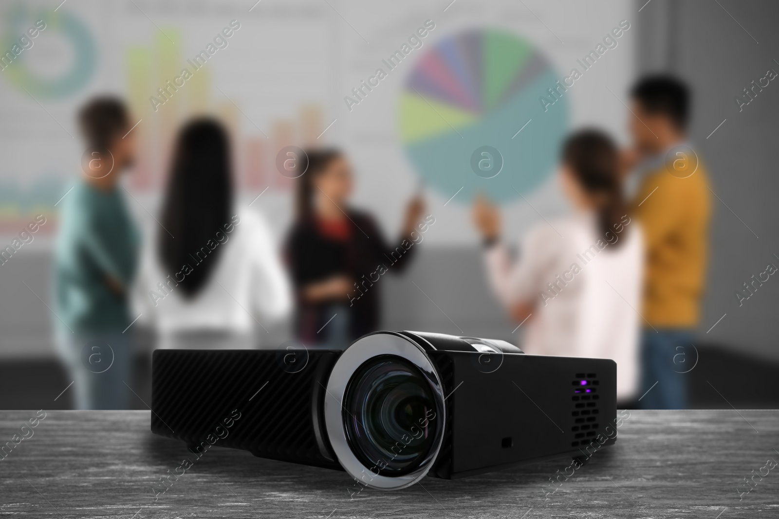 Image of Modern video projector and blurred people on background