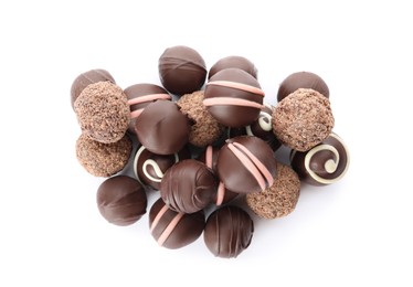 Many different delicious chocolate truffles on white background, top view