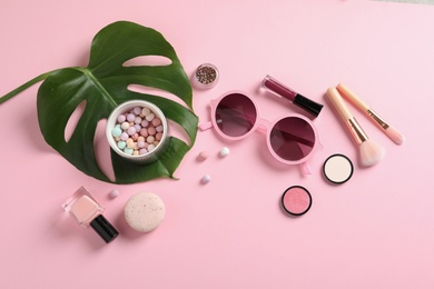 Photo of Flat lay composition with products for decorative makeup on pastel pink background