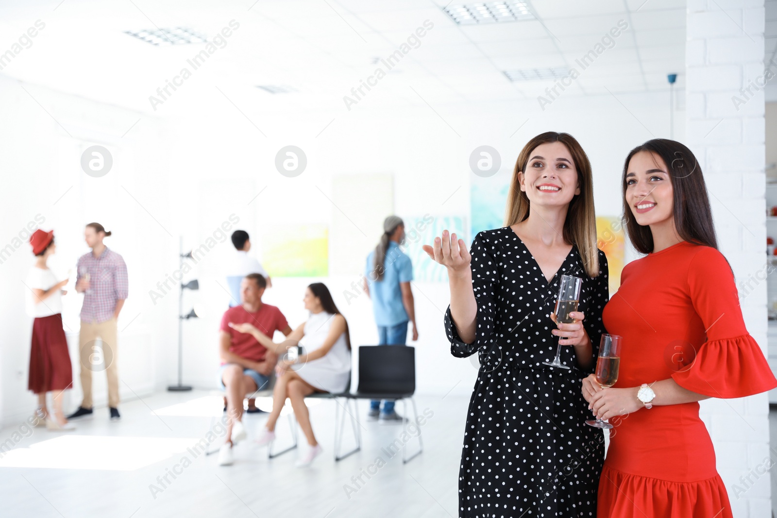 Photo of Beautiful women at exhibition in art gallery