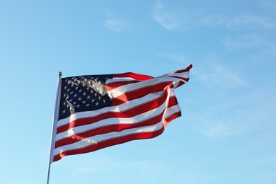 Photo of American flag fluttering outdoors on sunny day