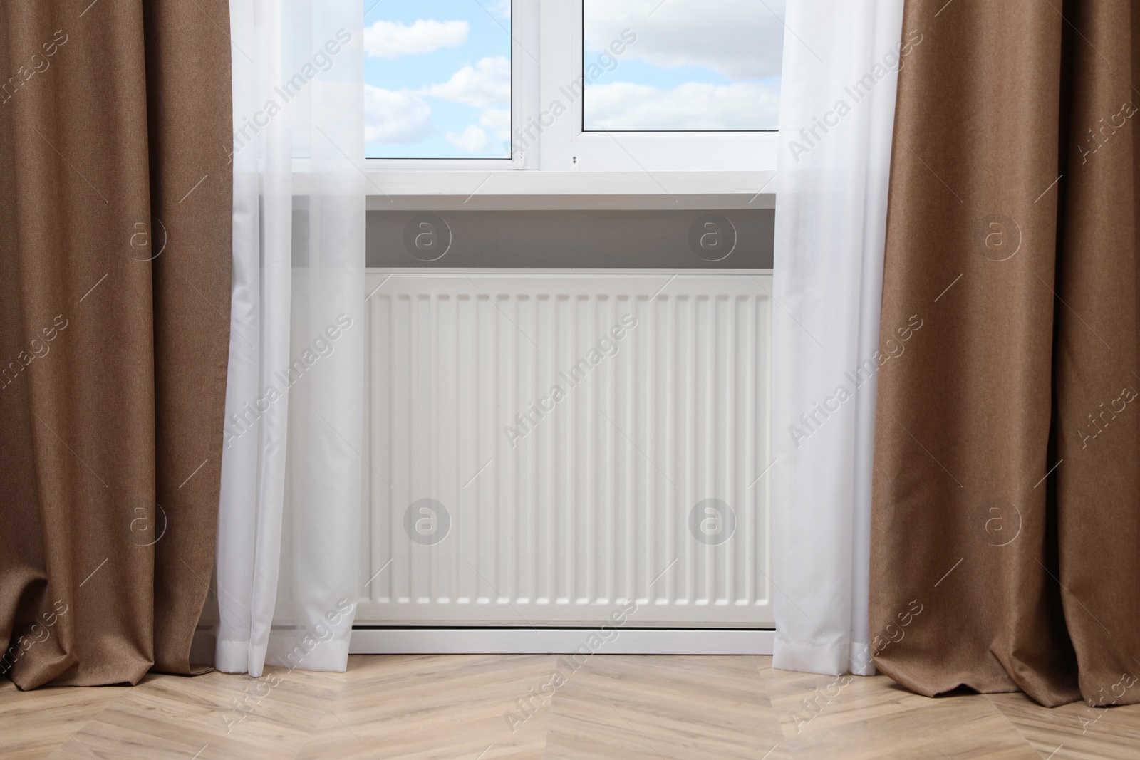 Photo of Modern radiator at home. Central heating system