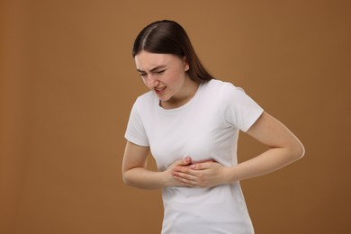 Photo of Woman having heart attack on brown background