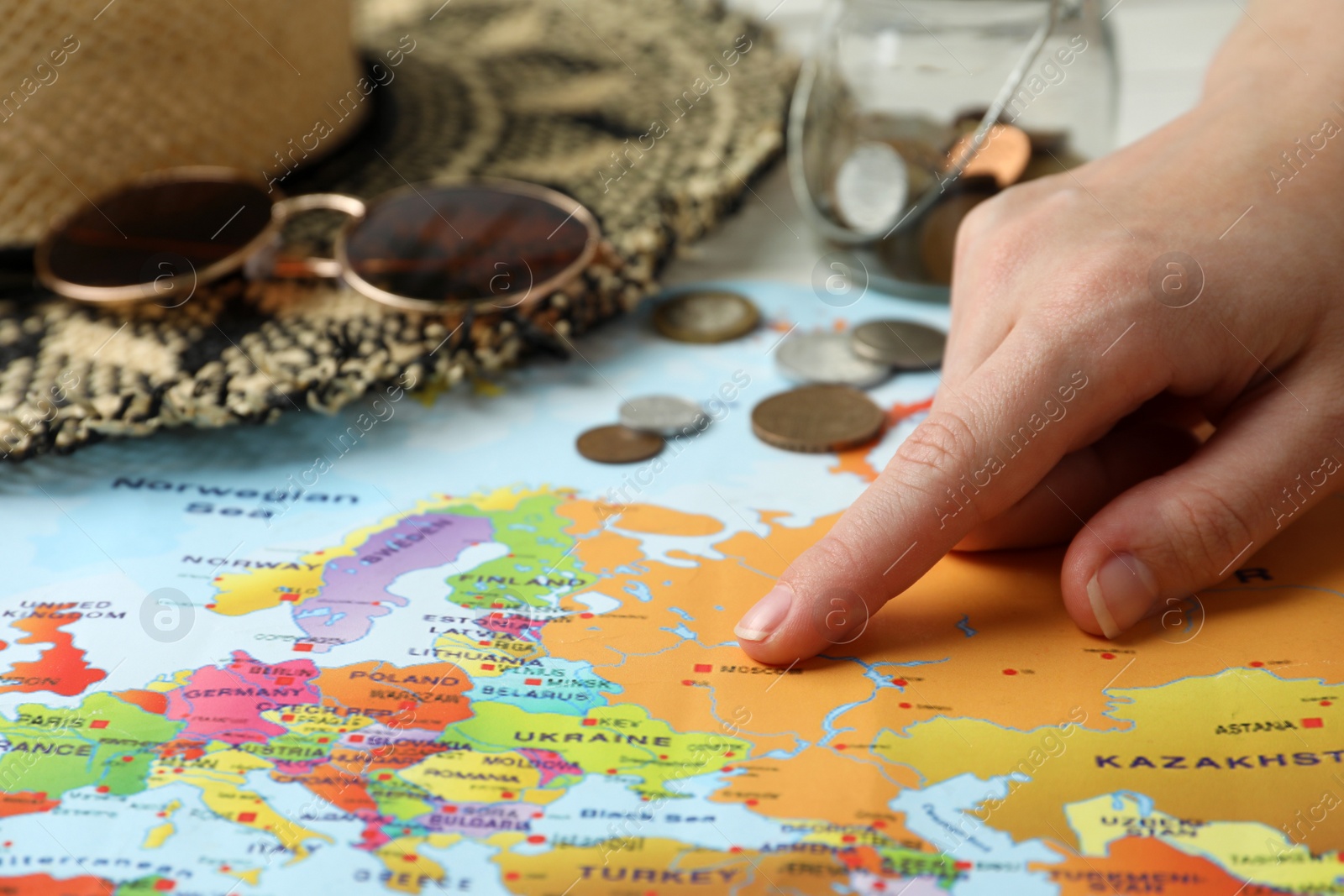 Photo of Woman with world map at table, closeup. Travel during summer vacation