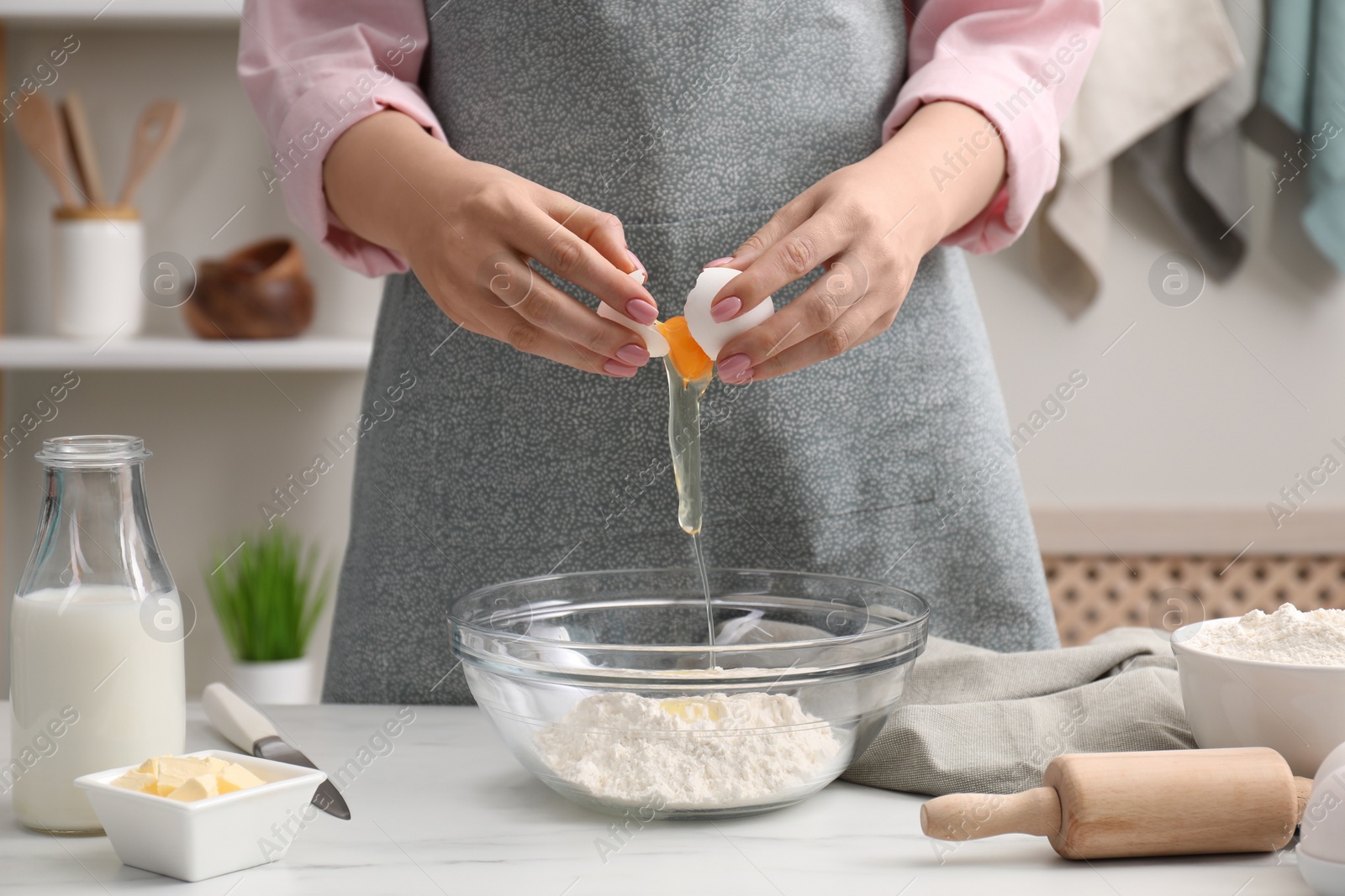 Photo of Preparing tasty baklava. Woman making dough at white table, closeup