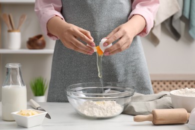 Preparing tasty baklava. Woman making dough at white table, closeup