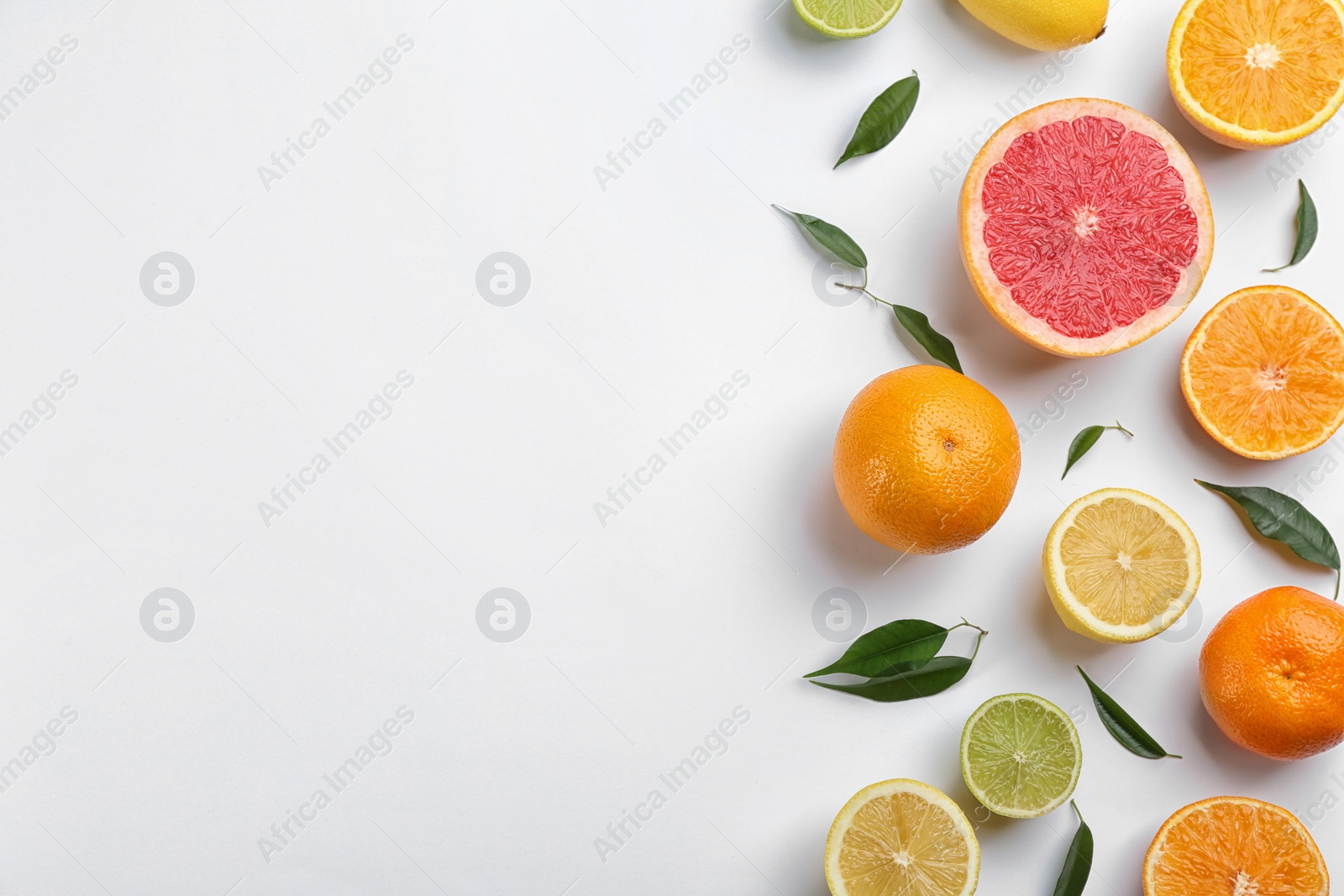 Photo of Flat lay composition with tangerines and different citrus fruits on white background. Space for text