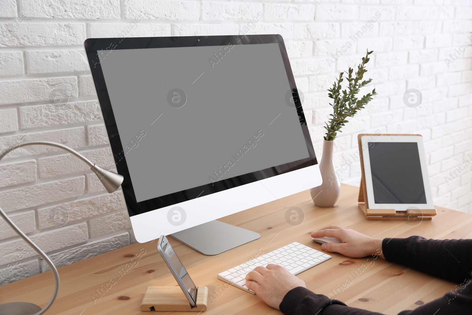 Photo of Young man using modern computer at table, closeup