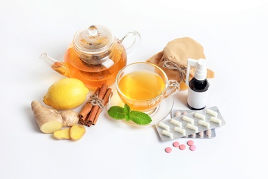 Photo of Natural and medical cold remedies on white background