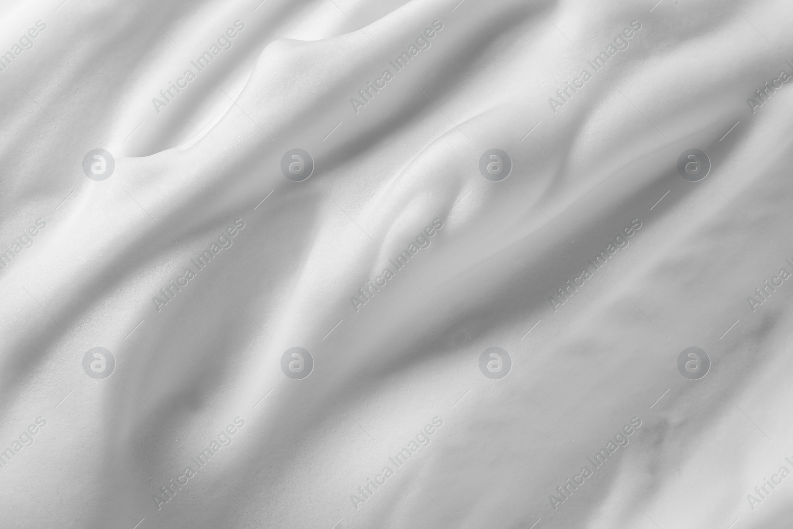 Photo of Texture of white shaving foam as background, top view