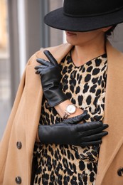 Young woman in stylish black leather gloves outdoors