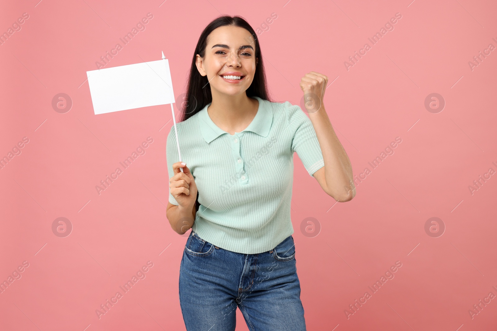 Photo of Happy young woman with blank white flag on pink background. Mockup for design