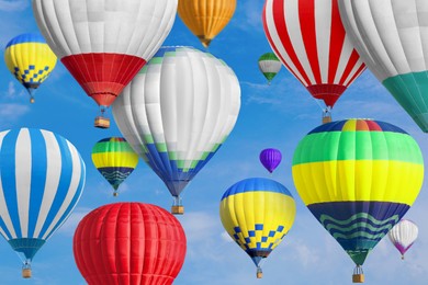 Image of Many bright hot air balloons flying in sky