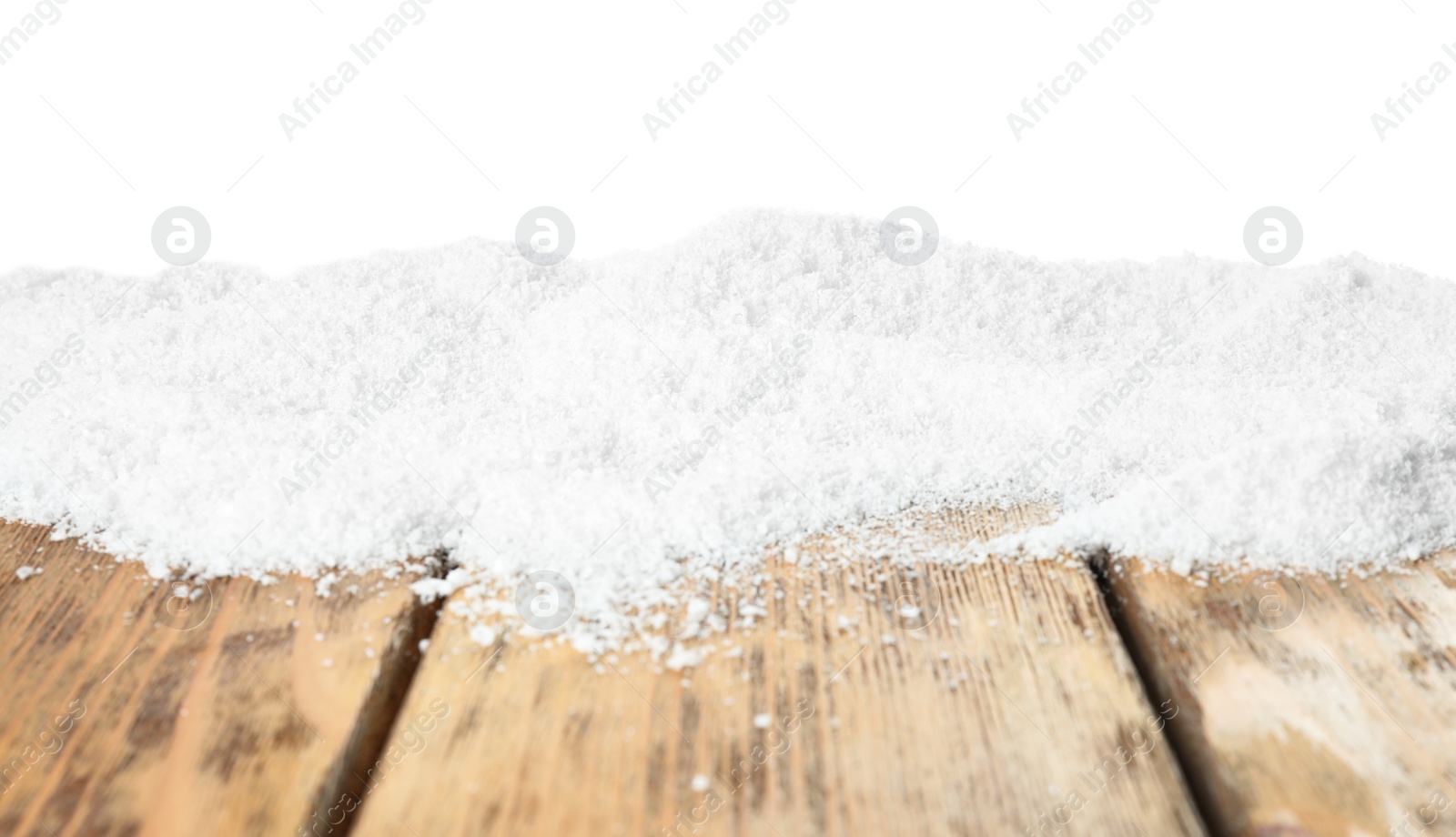 Photo of Snow on wooden table against white background. Christmas season