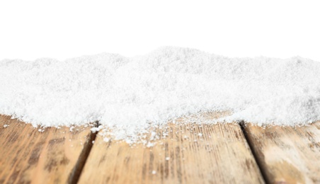 Photo of Snow on wooden table against white background. Christmas season