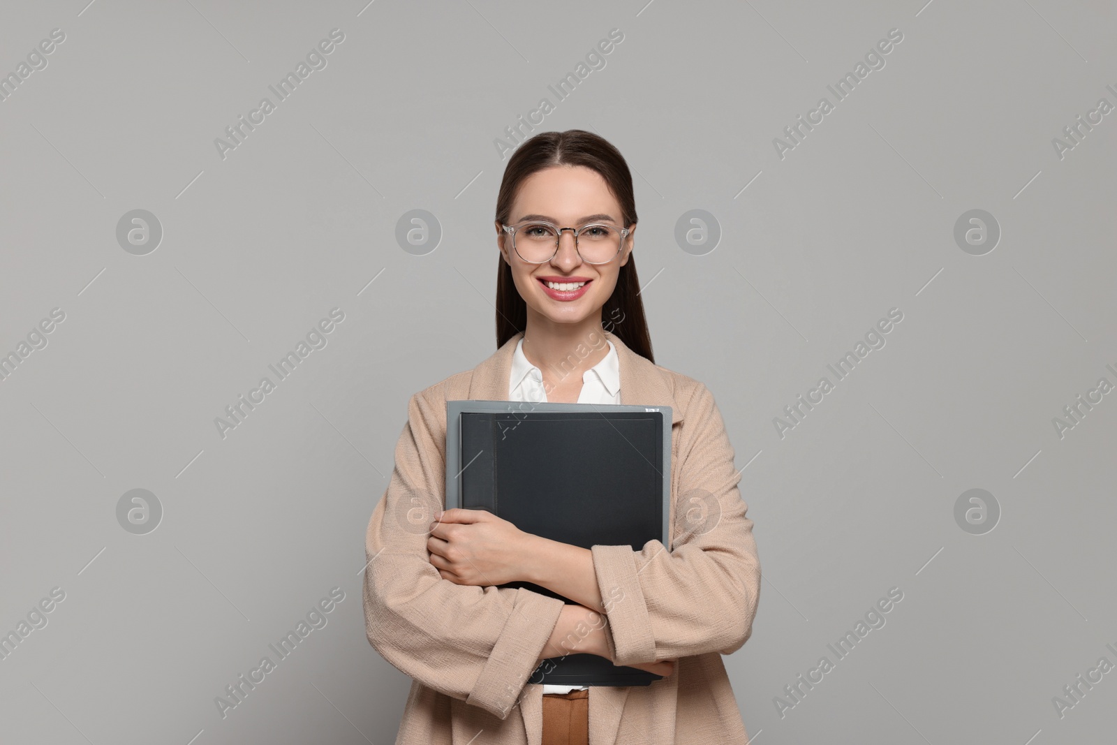 Photo of Portrait of beautiful young teacher on grey background