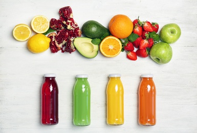 Photo of Flat lay composition with tasty juices and ingredients on light background