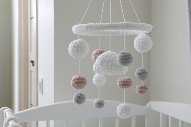 Modern baby mobile under crib in children's room