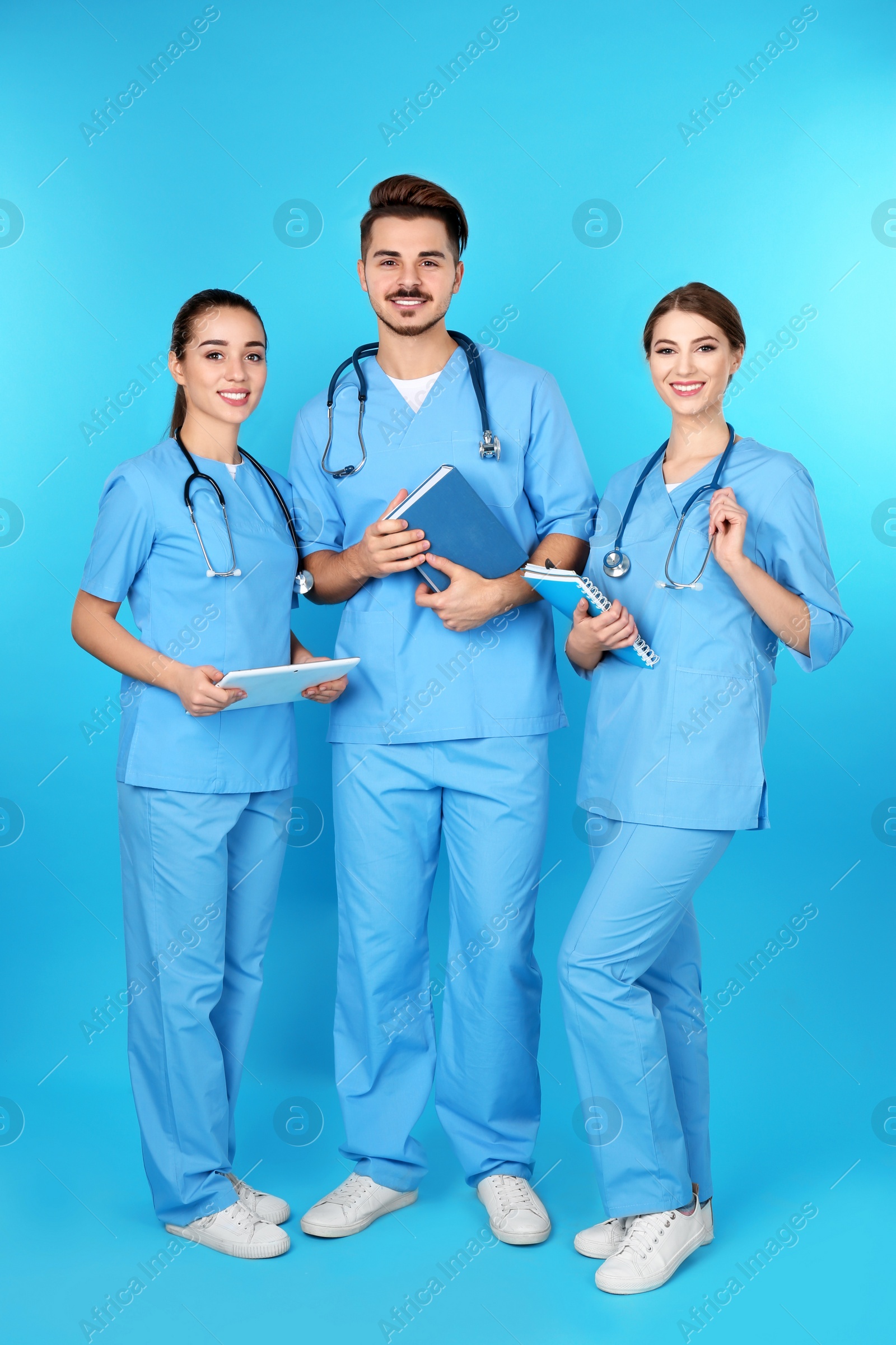 Photo of Group of young medical students on color background