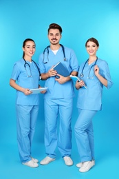 Photo of Group of young medical students on color background