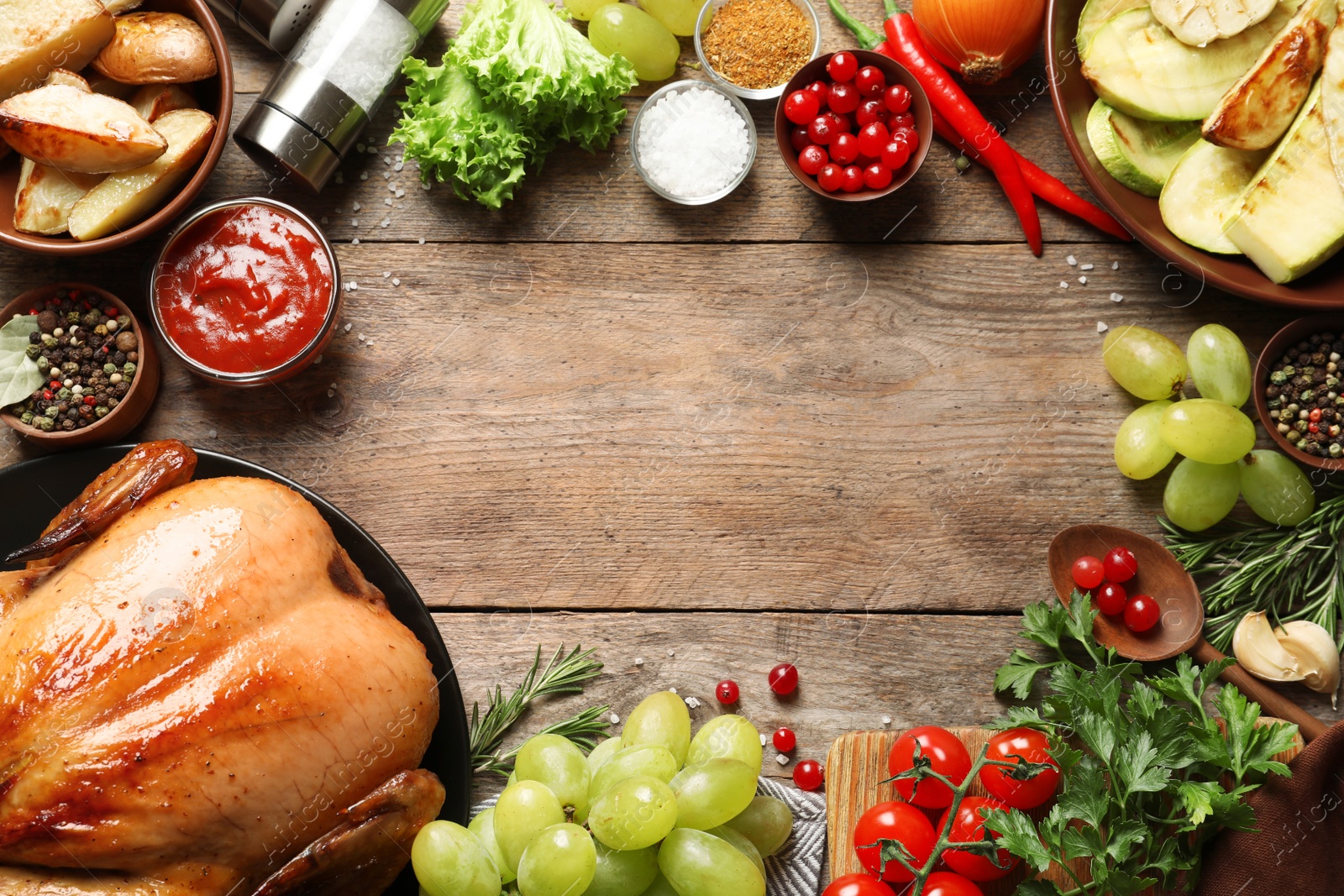 Photo of Frame of cooked turkey with vegetables, herbs and spices on wooden background, flat lay. Space for text