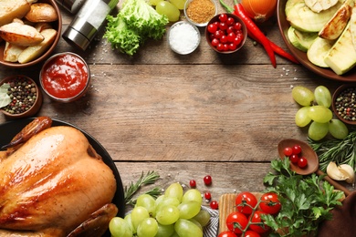 Photo of Frame of cooked turkey with vegetables, herbs and spices on wooden background, flat lay. Space for text