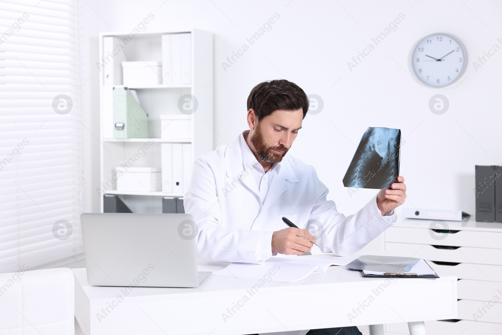 Photo of Doctor writing results from MRI scan in hospital