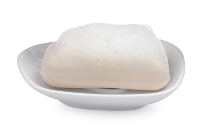 Soap bar with fluffy foam in holder on white background