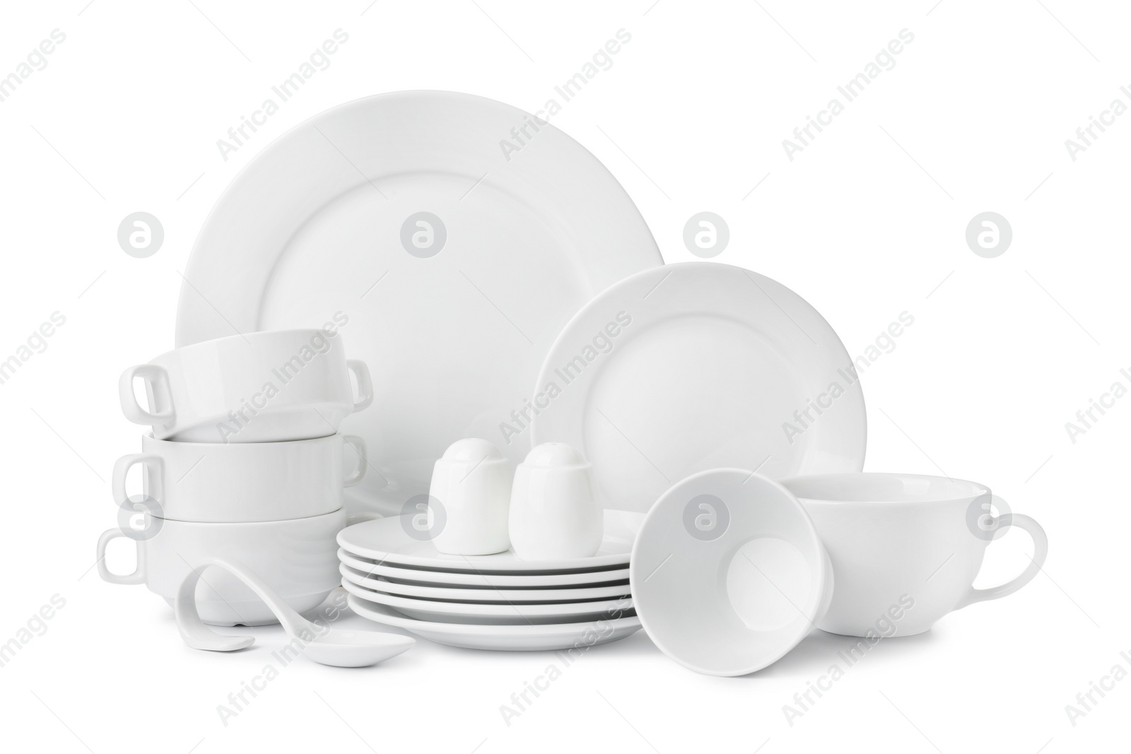 Photo of Set of clean dishware isolated on white